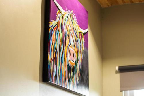 a painting of a lion on a wall at Culbokie Lodges in Culbokie