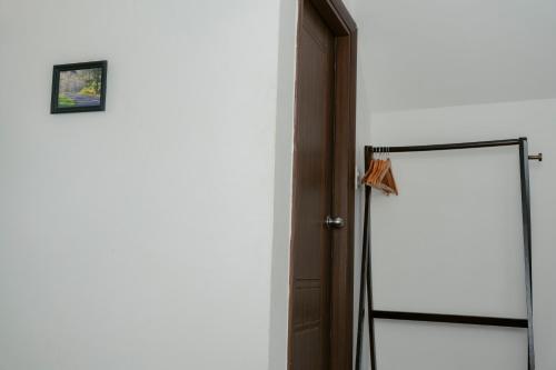 a bathroom with a shower stall and a door at Michelia Valley Hotel in Da Lat