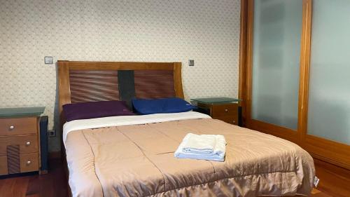 a bedroom with a large bed with two night stands at Douro Villa in Porto