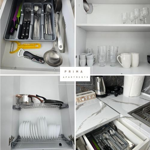 a white kitchen with utensils and utensils at Prima Apartments in Pogradec