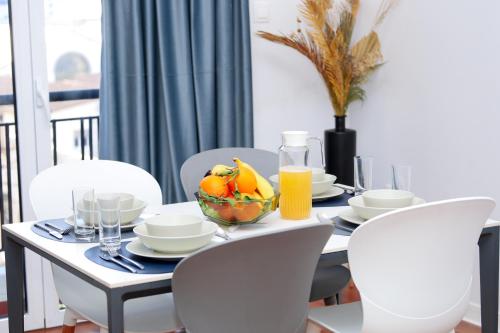 a dining room table with a bowl of fruit on it at Ecrin d'élégance au coeur d'Alger in Sidi MʼHamed