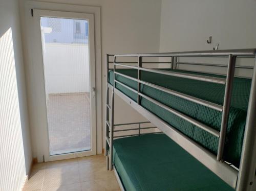 a staircase in a room with a door at Appartamento MaRi con piscina in Torre Lapillo