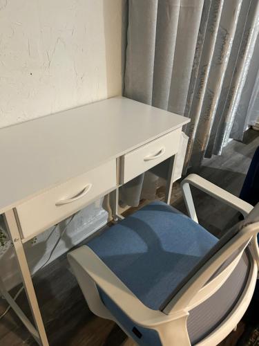 a white desk with a chair next to a table at Cozy Studio only 10 minutes by car of Siesta Key in Sarasota
