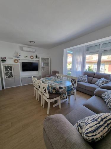 a living room with a couch and a table at Apartamento de lujo en Playa de Regla in Chipiona
