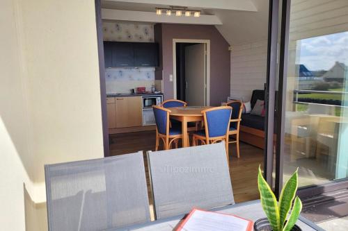 a kitchen and dining room with a table and chairs at Tipoz'immo-Le Grand Grand 210 -view and direct access to the sea-pets accep in Pouldreuzic