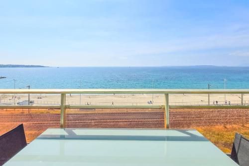 a balcony with a view of the beach and the ocean at Apartment 4 guests front of the sea in Antibes