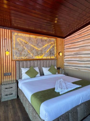a bedroom with a large white bed in a room at Harmony Heights in Mukteswar