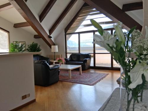 a living room with couches and a table at Hotel Ristorante Vapore in Faggeto Lario 