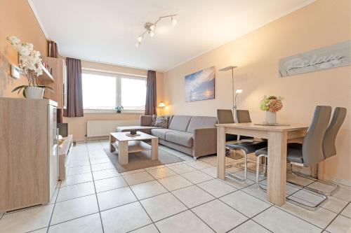 a living room with a couch and a table at Haus Meeresgruß Relax in Grömitz