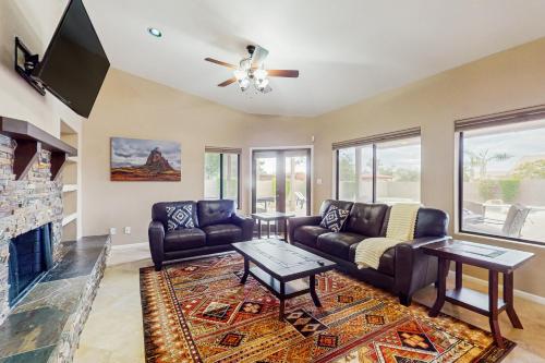 a living room with couches and a fireplace at The Peoria Palms in Peoria