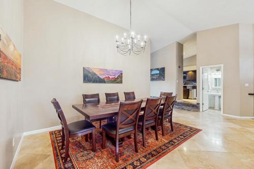 a dining room with a table and chairs at The Peoria Palms in Peoria