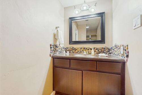 a bathroom with a sink and a mirror at The Peoria Palms in Peoria