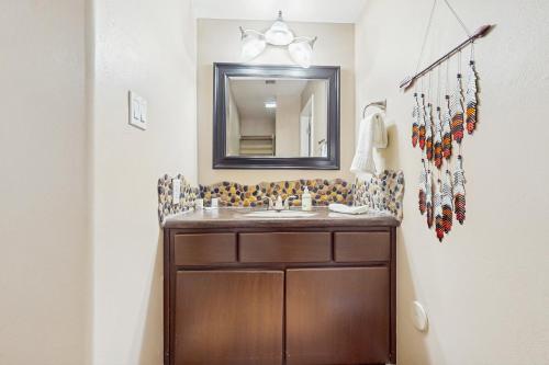 a bathroom with a sink and a mirror at The Peoria Palms in Peoria
