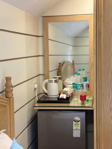 a small kitchen with a counter with a coffee maker at Sea Breeze, Guhagar in Guhagar