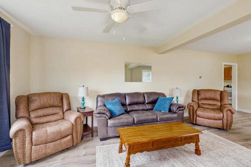 a living room with two chairs and a couch and a table at The Farm House in Bear Lake