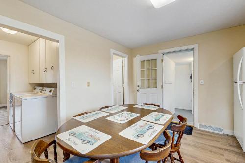 a kitchen with a table and chairs and a refrigerator at The Farm House in Bear Lake