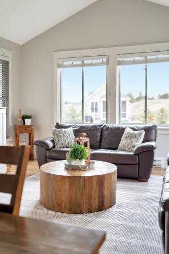 a living room with a couch and a coffee table at The Kiskadee - 49 Butternut in Cherry Valley