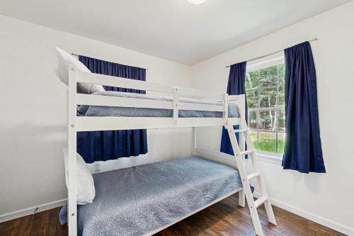 a bedroom with two bunk beds and a window at Holly Park --- 36568 Berry Ct in Ocean View