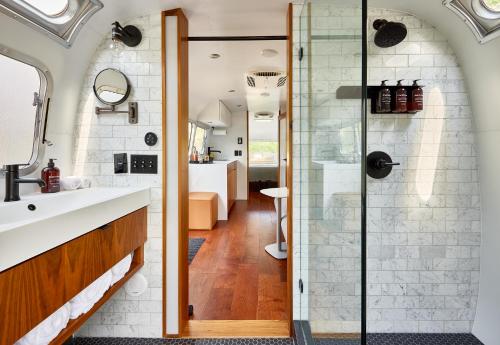 a bathroom with a sink and a glass shower at AutoCamp Sequoia in Three Rivers