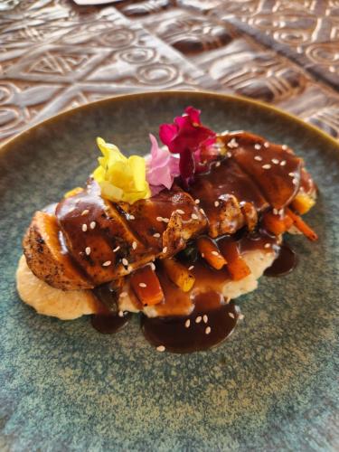 a plate with a dessert with chocolate and flowers on it at The Foresta Resort ,Mulshi in Paud