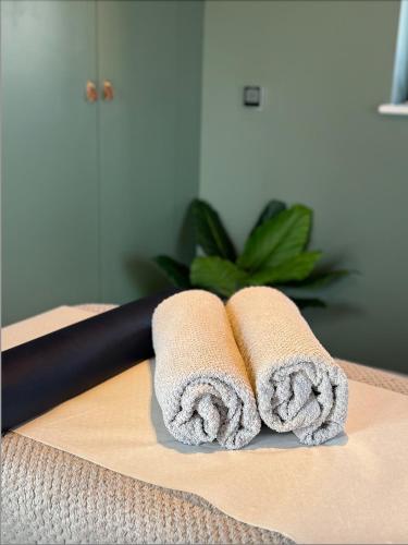two towels sitting on top of a table at Malvern, The Mount Barns & Spa in Elmley Lovett