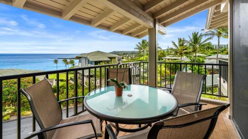 a table and chairs on a balcony with the ocean at Kapalua Bay Villa 17B4 in Kapalua