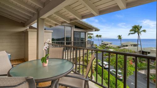 a balcony with a table and chairs and the ocean at Kapalua Bay Villa 17B4 in Kapalua