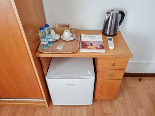 a small wooden desk with a washer and dryer at Dolce Vianna - City Centre Rooms in Viana do Castelo