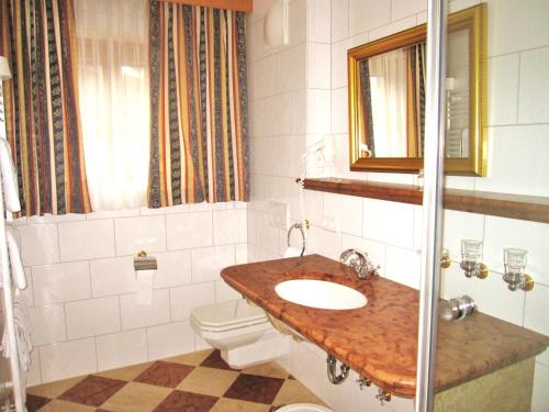 a bathroom with a sink and a toilet at Gasthof Hotel Doktorwirt in Salzburg