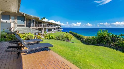 a bench on a brick walkway in front of a house at Kapalua Bay Villa 18G2 in Kapalua