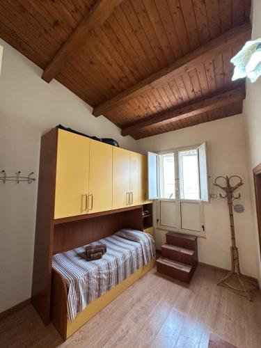 a bedroom with a bed and a wooden ceiling at Affaccio sul Mare in Tropea