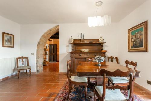 a dining room with a table and a piano at Casale Bianca Luce in Santa Luce