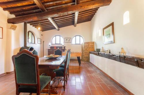 a dining room with a wooden table and chairs at Casale Bianca Luce in Santa Luce