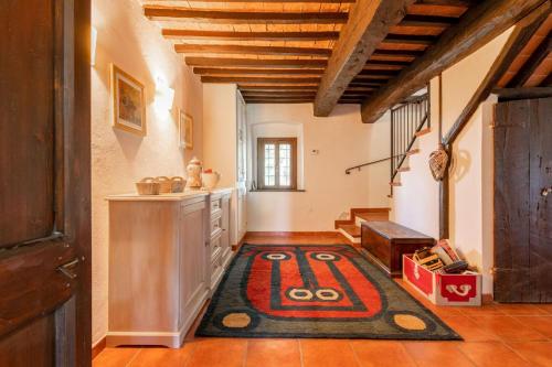 a hallway with a rug on the floor in a house at Casale Bianca Luce in Santa Luce