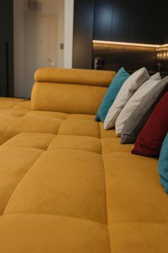 a row of beds with colorful pillows on them at Herăstrău WIN Résidence No 4 in Bucharest