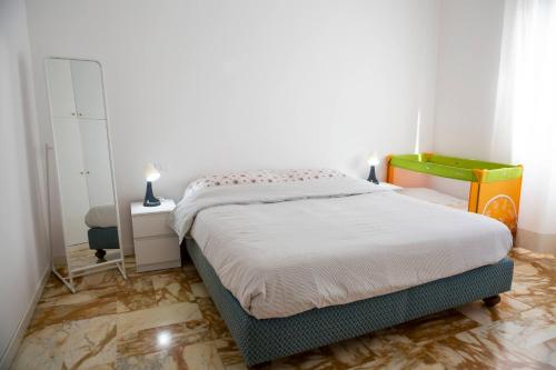 a bedroom with a bed and a dresser and a mirror at Casa di Pier&Chico in Genova