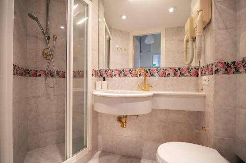 a bathroom with a toilet and a sink and a shower at Casa di Pier&Chico in Genova