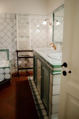 a bathroom with a sink and a mirror at La Dimora degli ulivi in SantʼAlfio