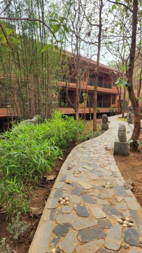 a stone walkway in front of a building at The Foresta Resort ,Mulshi in Paud