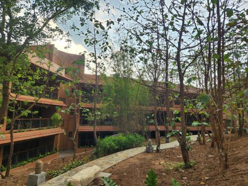 a building with trees in front of it at The Foresta Resort ,Mulshi in Paud
