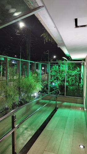 a room with green lights in a building at Quarto-Sala 550 mts Praia Camburi e Próximo Universidade UFES in Vitória