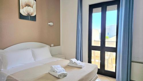 Postel nebo postele na pokoji v ubytování Hotel Baia del Cigno