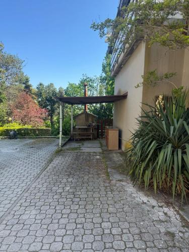 a stone walkway with a pavilion next to a building at PM 34 Strada delle Primule in Pesaro