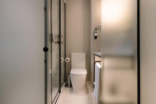 a bathroom with a white toilet in a room at Pestana Rua Augusta Lisboa in Lisbon