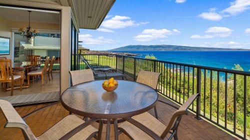 a table on a balcony with a view of the ocean at Kapalua Bay Villa 21G2 in Kapalua
