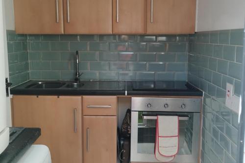 a kitchen with a stove and a sink at Cosy Cork - House - Sleeps 4 - City Centre in Cork