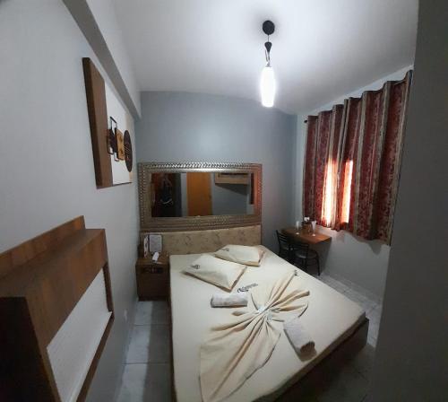 a bedroom with a bed and a sink in it at Motel Reality in Sao Paulo