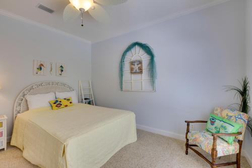 a bedroom with a bed and a chair and a window at Fish, Boat and Unwind Creekside Oasis in Darien! in Darien