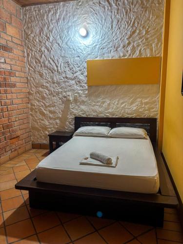 a bed sitting in a room with at Hotel Casa Madrid in Puerto Berrío