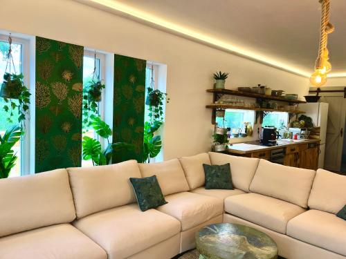 a white couch in a living room with a table at Bohemian Lodge in Kisapáti